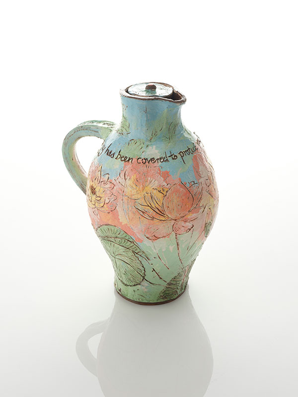 Small covered decorated jug